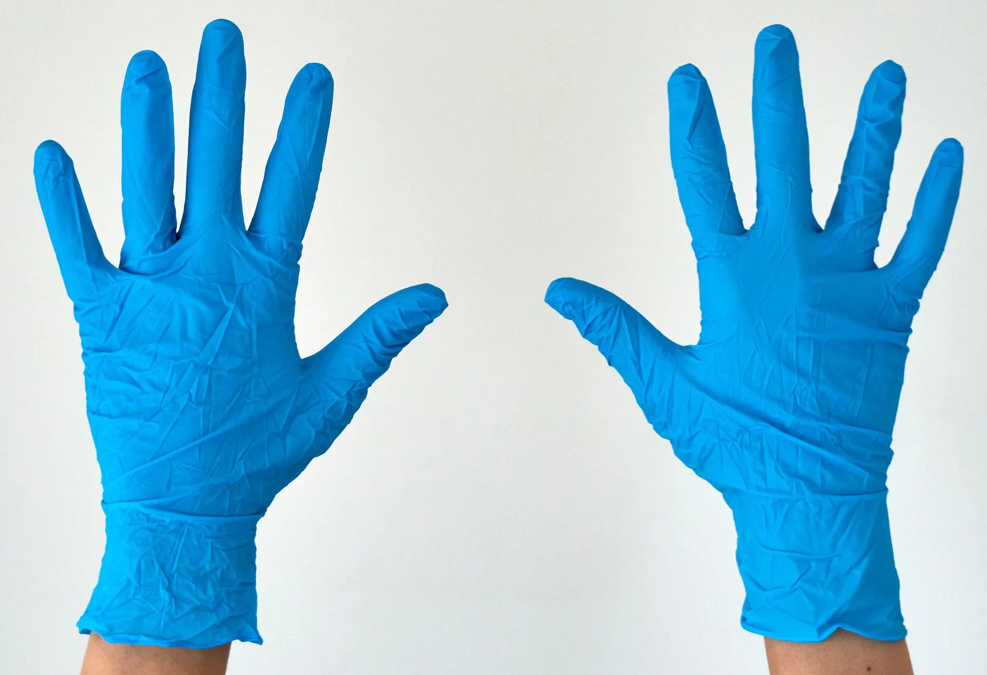 Hands in blue nitrile gloves