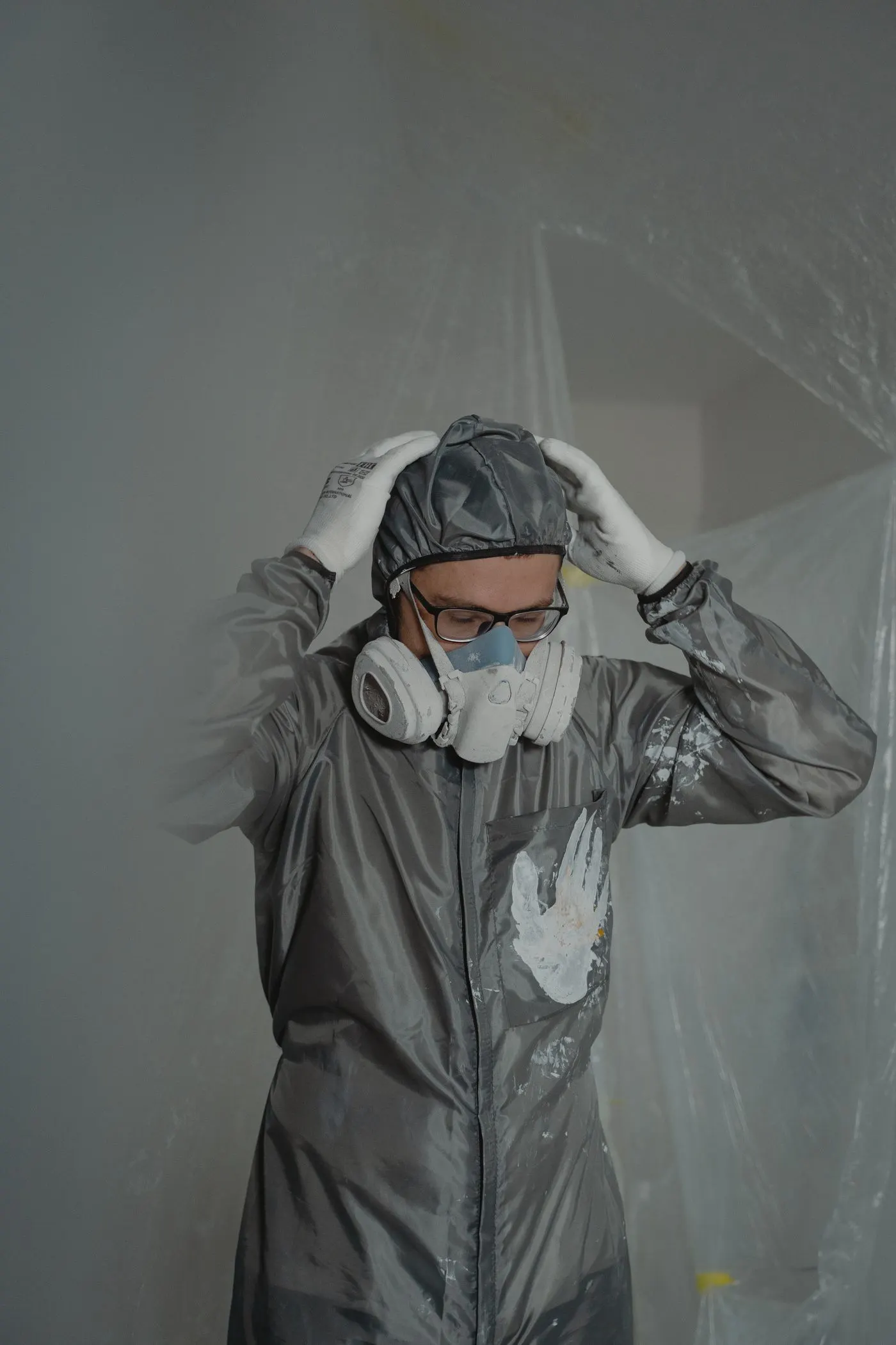 Worker in disposable coverall and respirator